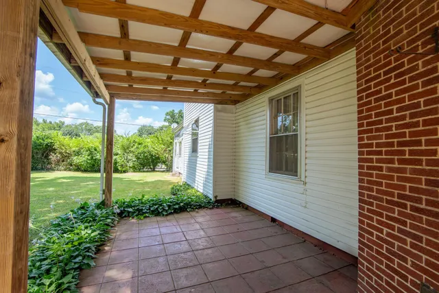 a front view of a house with a yard and outdoor seating