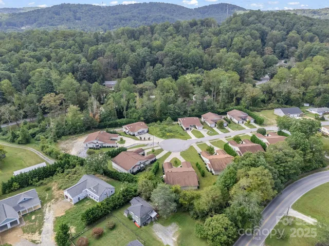 an aerial view of residential houses with outdoor space and street view