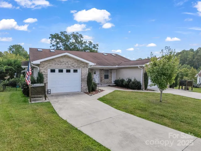a front view of a house with a garden and yard