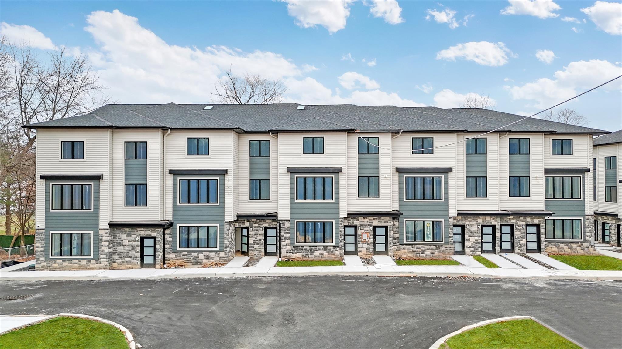 a view of a brick house with a swimming pool and furniture