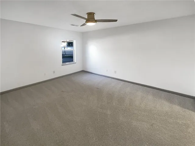 an empty room with a empty space and windows