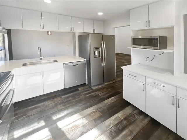 a kitchen with a sink a refrigerator and a stove