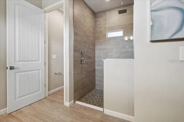 a bathroom with a shower and mirror