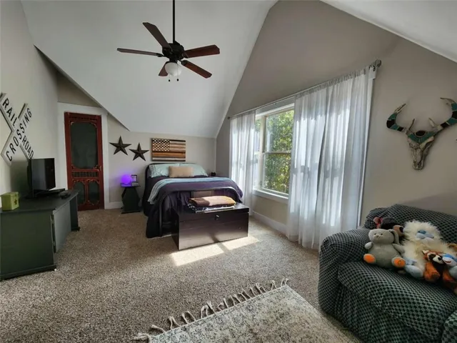 a bedroom with bed and a window