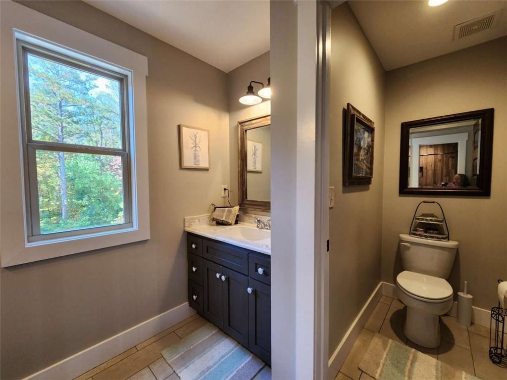 7350 Banks Mill Road Douglasville, GA 30135 - Photo 18 of 27 a spacious bathroom with a toilet sink and mirror