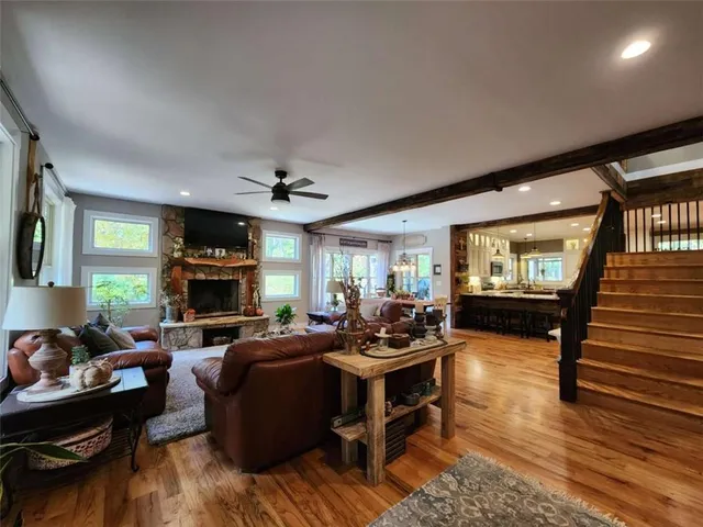 a living room with furniture a fireplace and a flat screen tv