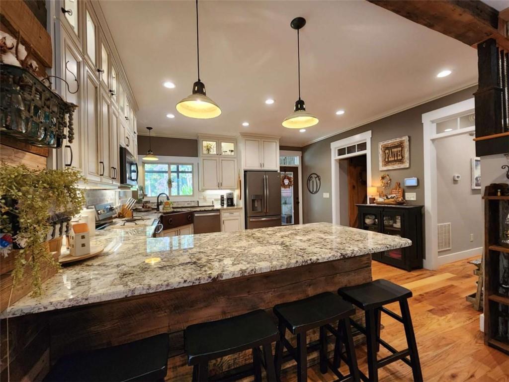 7350 Banks Mill Road Douglasville, GA 30135 - Photo 7 of 27 a kitchen with stainless steel appliances granite countertop a stove a refrigerator a oven a sink with island and chairs