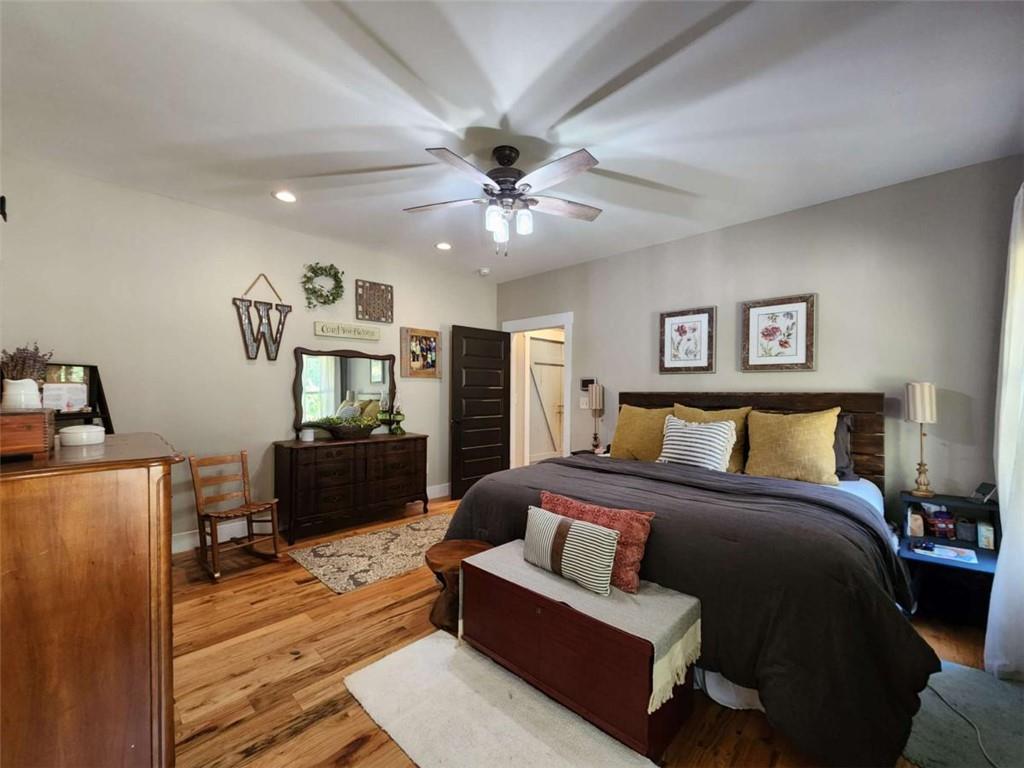 7350 Banks Mill Road Douglasville, GA 30135 - Photo 8 of 27 a spacious bedroom with a bed and wooden floor