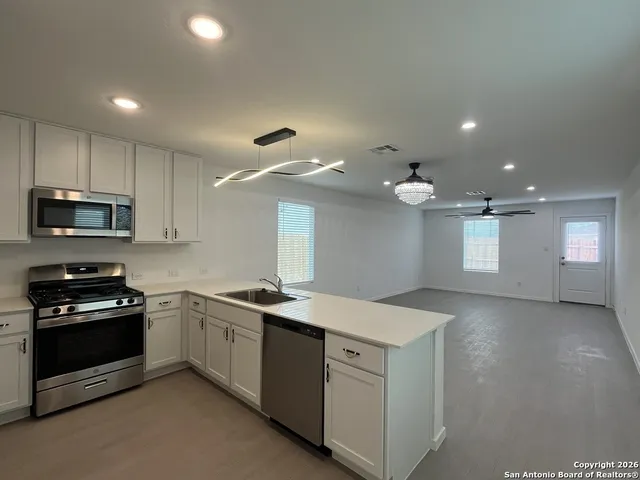 a kitchen with a sink stainless steel appliances and cabinets
