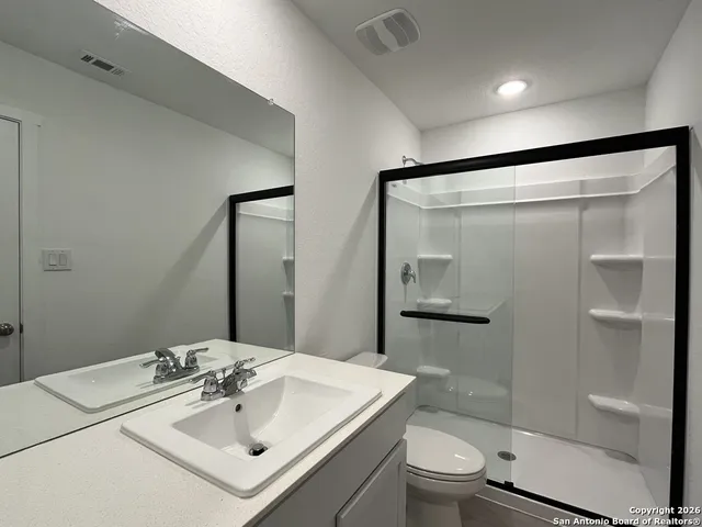 a bathroom with a sink toilet and shower