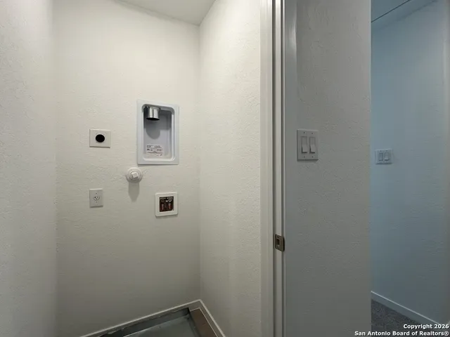 a bathroom with a white wall