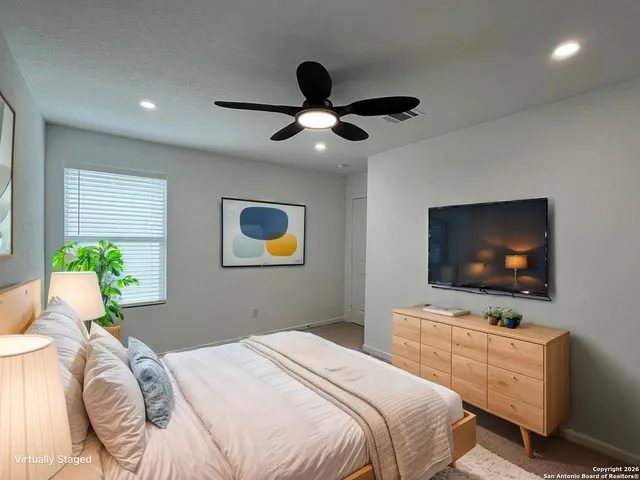 a bedroom with bed and a flat screen tv