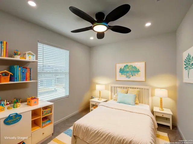 a bedroom with a bed cabinets and window
