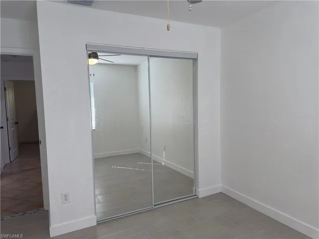 an empty room with a mirror