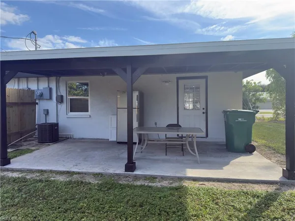 a view of a patio with table and chairs and potted plants