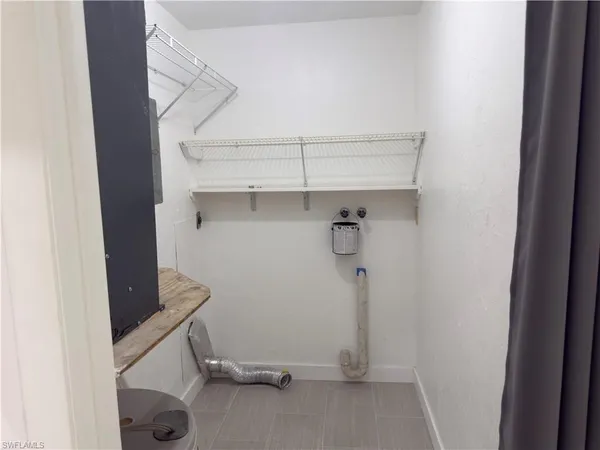 a view of storage and utility room with racks on the wall