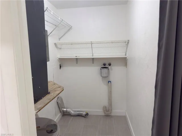 a view of storage and utility room with racks on the wall