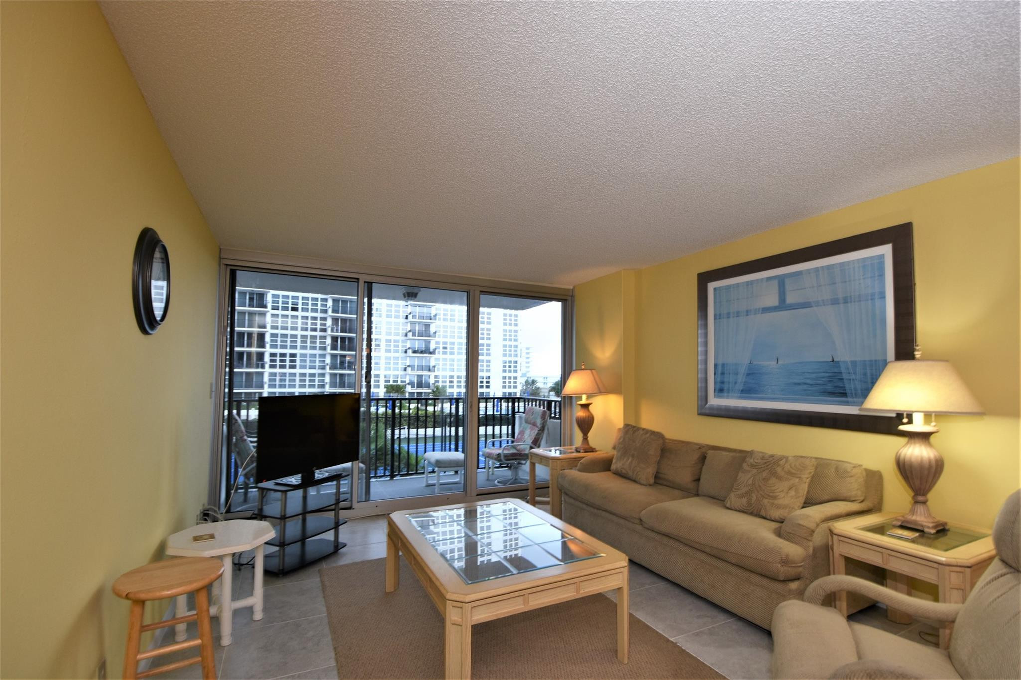 525 North Ocean Boulevard, Unit 522 Pompano Beach, FL 33062 - Photo 11 of 34 a living room with furniture and a flat screen tv