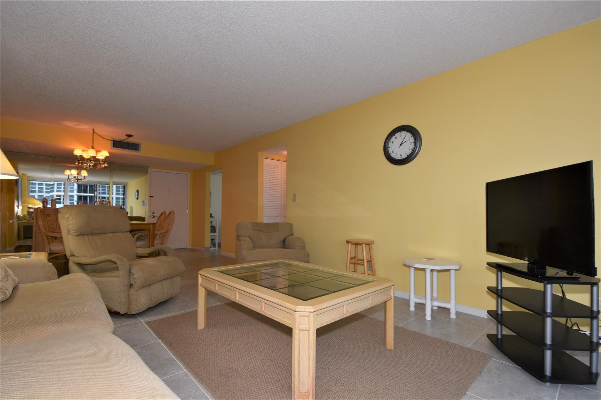 525 North Ocean Boulevard, Unit 522 Pompano Beach, FL 33062 - Photo 12 of 34 a living room with couches and a flat screen tv