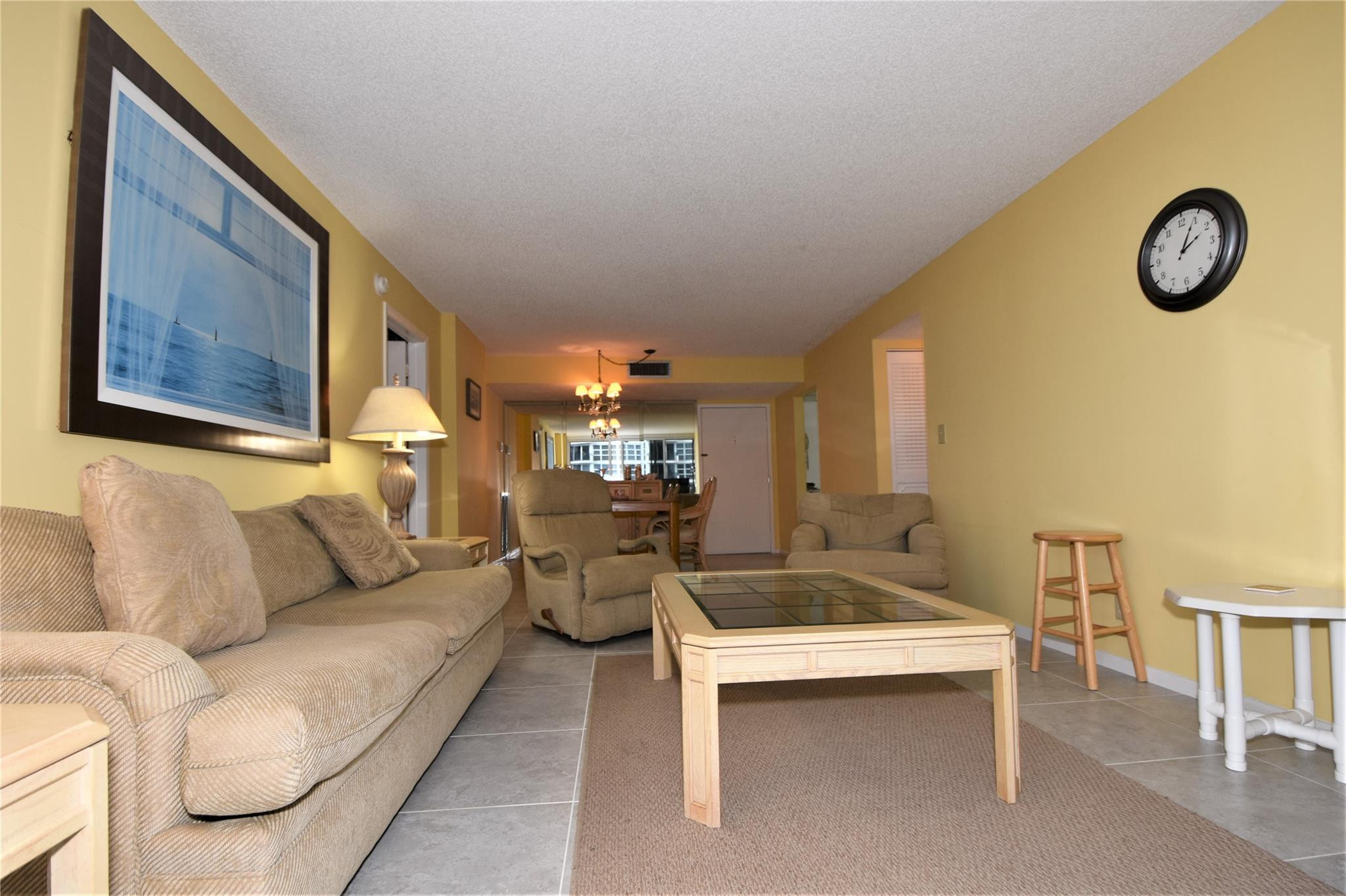 525 North Ocean Boulevard, Unit 522 Pompano Beach, FL 33062 - Photo 13 of 34 a living room with couches and a table with rug
