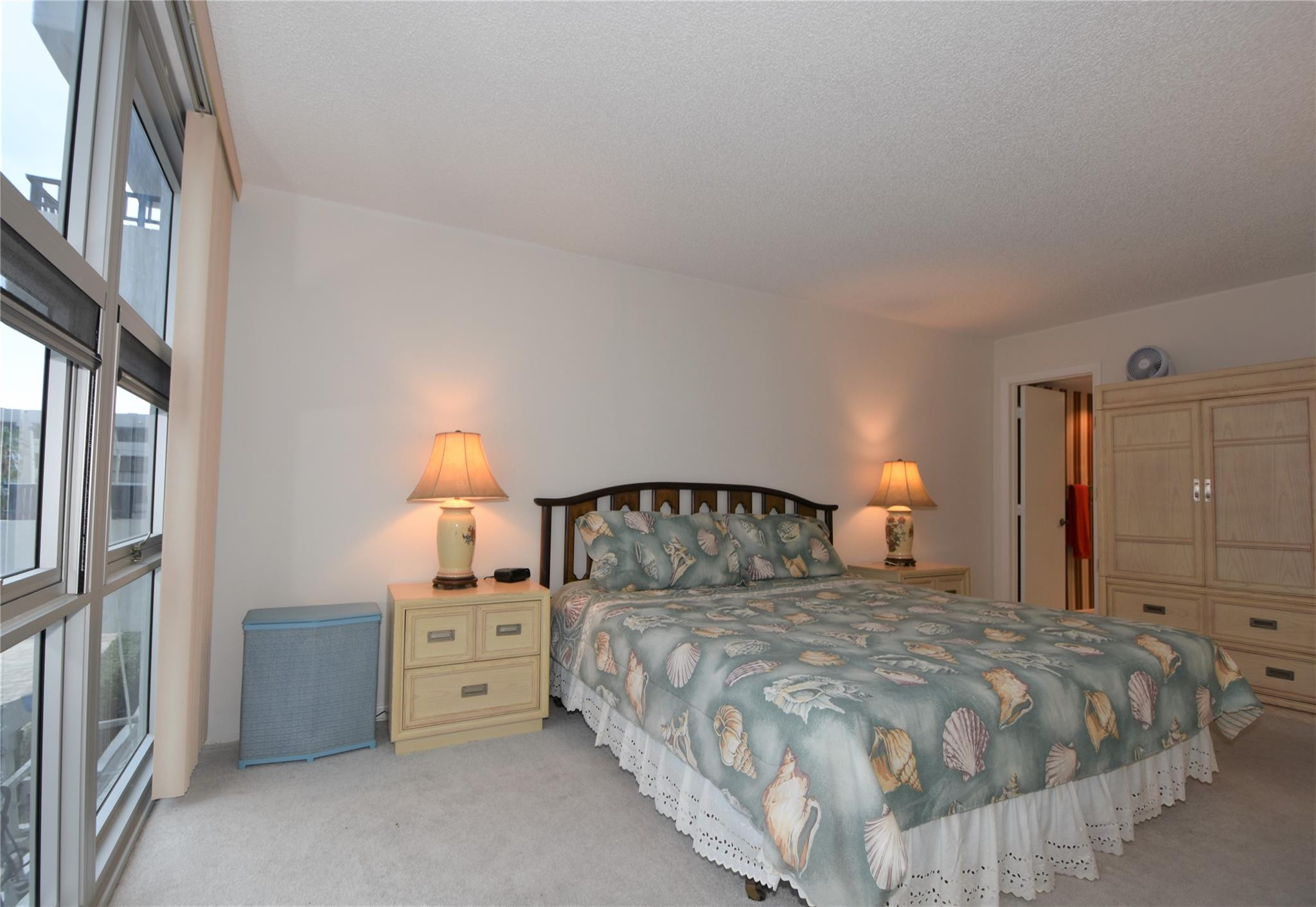 525 North Ocean Boulevard, Unit 522 Pompano Beach, FL 33062 - Photo 19 of 34 a bedroom with a bed and a lamp with window