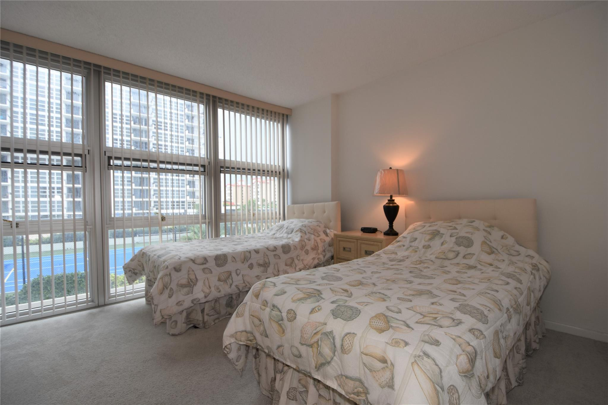 525 North Ocean Boulevard, Unit 522 Pompano Beach, FL 33062 - Photo 25 of 34 a bed sitting in a bedroom next to a window