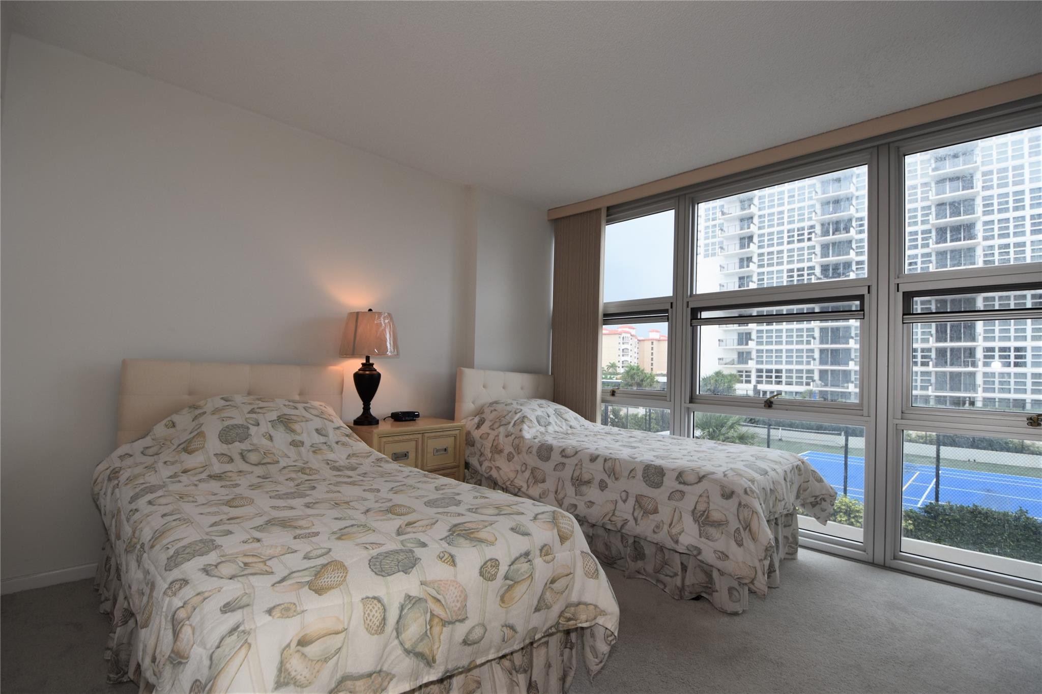 525 North Ocean Boulevard, Unit 522 Pompano Beach, FL 33062 - Photo 26 of 34 a bedroom with two beds and a large window