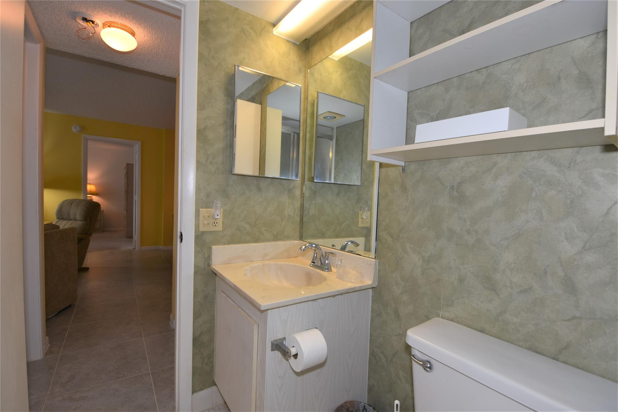 525 North Ocean Boulevard, Unit 522 Pompano Beach, FL 33062 - Photo 30 of 34 a bathroom with a sink a toilet and shower