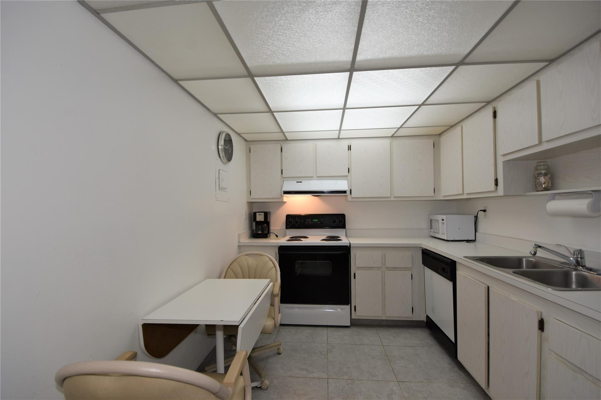 525 North Ocean Boulevard, Unit 522 Pompano Beach, FL 33062 - Photo 5 of 34 a kitchen with cabinets and stainless steel appliances