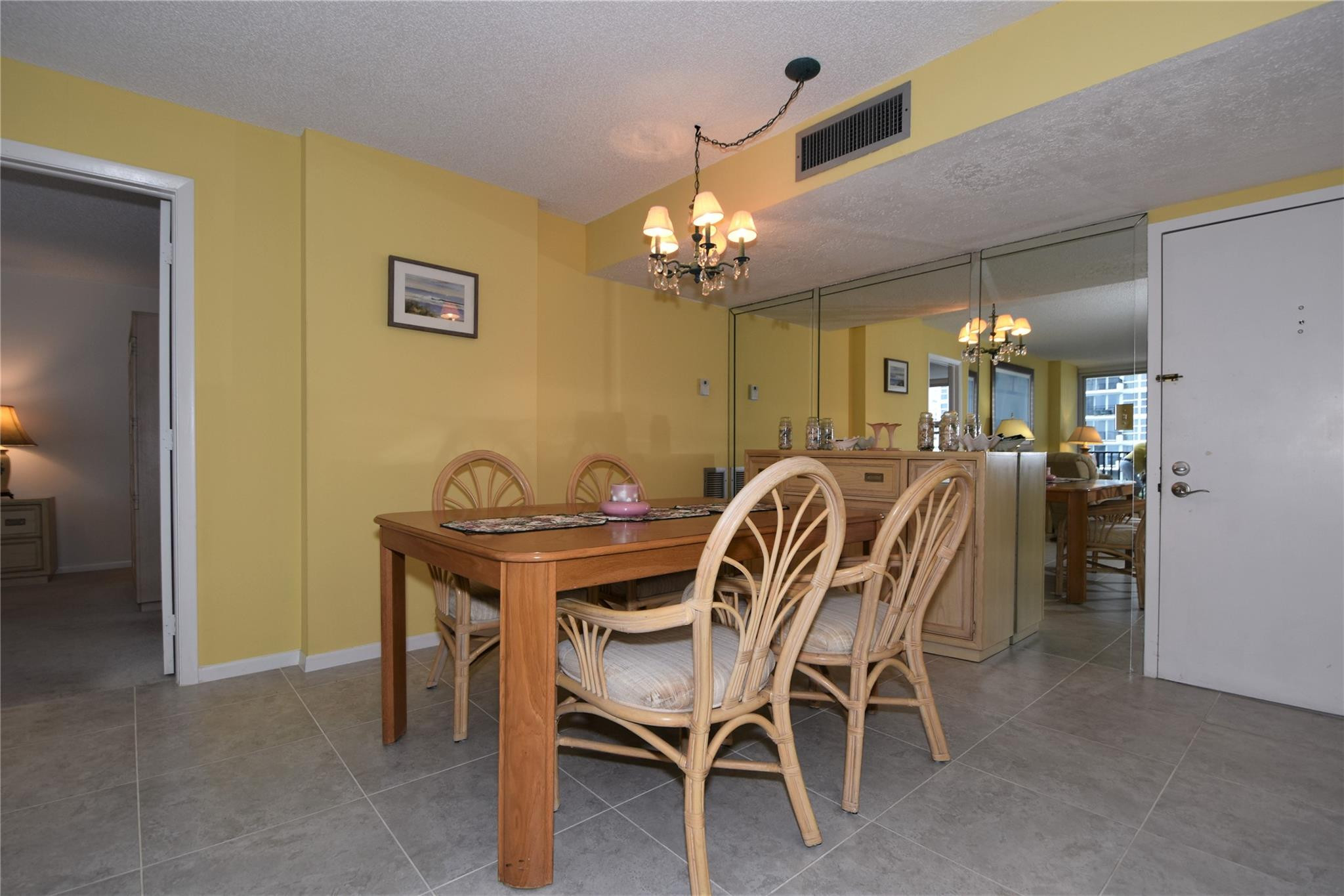 525 North Ocean Boulevard, Unit 522 Pompano Beach, FL 33062 - Photo 8 of 34 a view of a dining room with furniture and chandelier