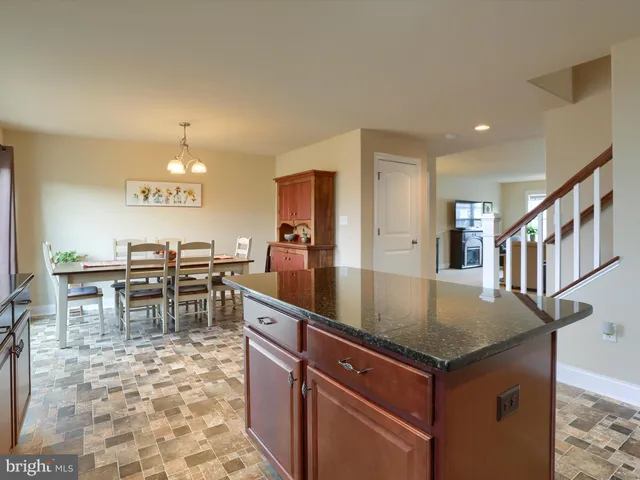 a view of kitchen island with granite countertop window
