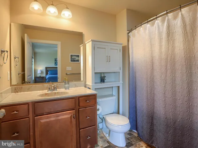 a bathroom with a toilet sink and mirror