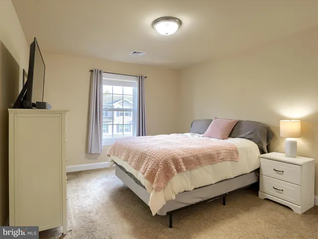 a bed room with a bed and a window