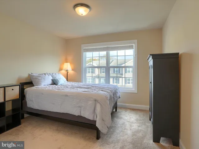 a bed sitting in a bedroom next to a window
