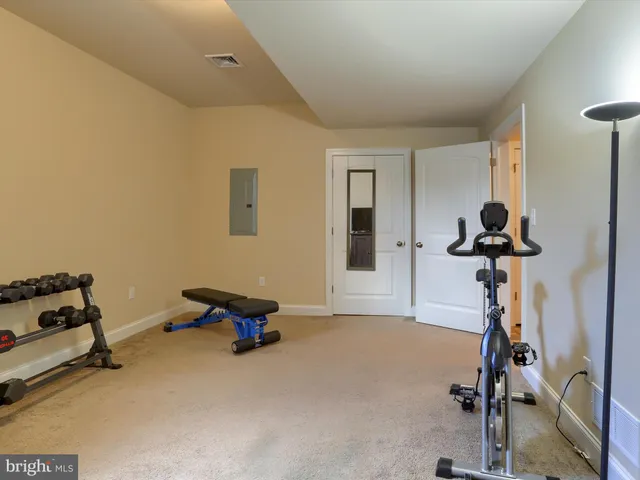 a room with gym equipment and a window