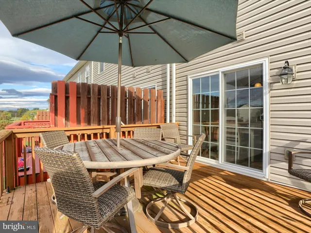 a view of a patio with a table and chairs
