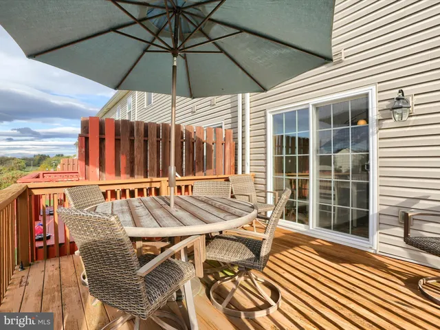 a view of balcony with two chairs and a umbrella