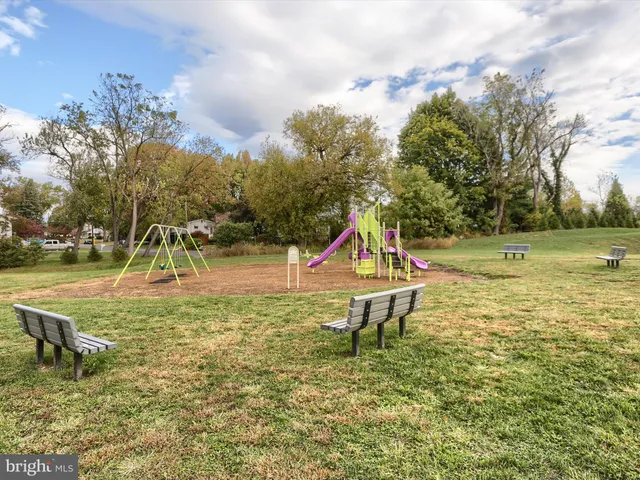 a view of a park with swings and slides