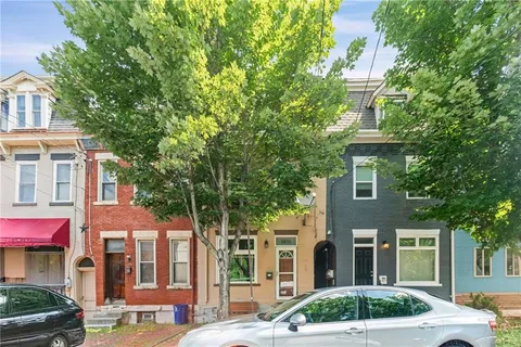 a front view of a residential apartment building with a yard