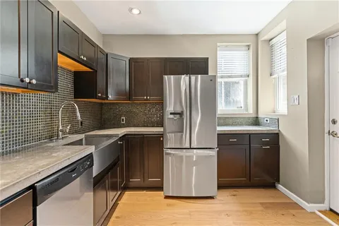 a kitchen with a refrigerator and a sink