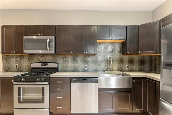 a kitchen with a sink and a stove top oven