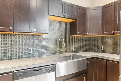 a kitchen with a sink cabinets and a window