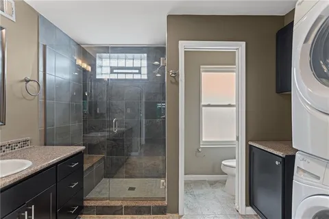 a bathroom with a shower a toilet and a sink