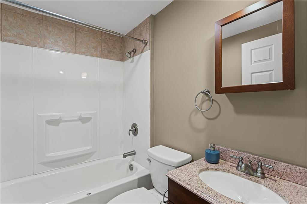 2815 Jane Street Pittsburgh, PA 15203 - Photo 30 of 42 a bathroom with a granite countertop sink a toilet and shower