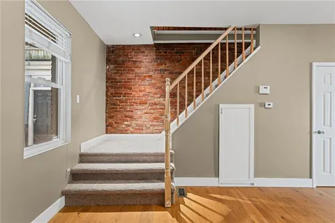 a view of entryway and hall with wooden floor
