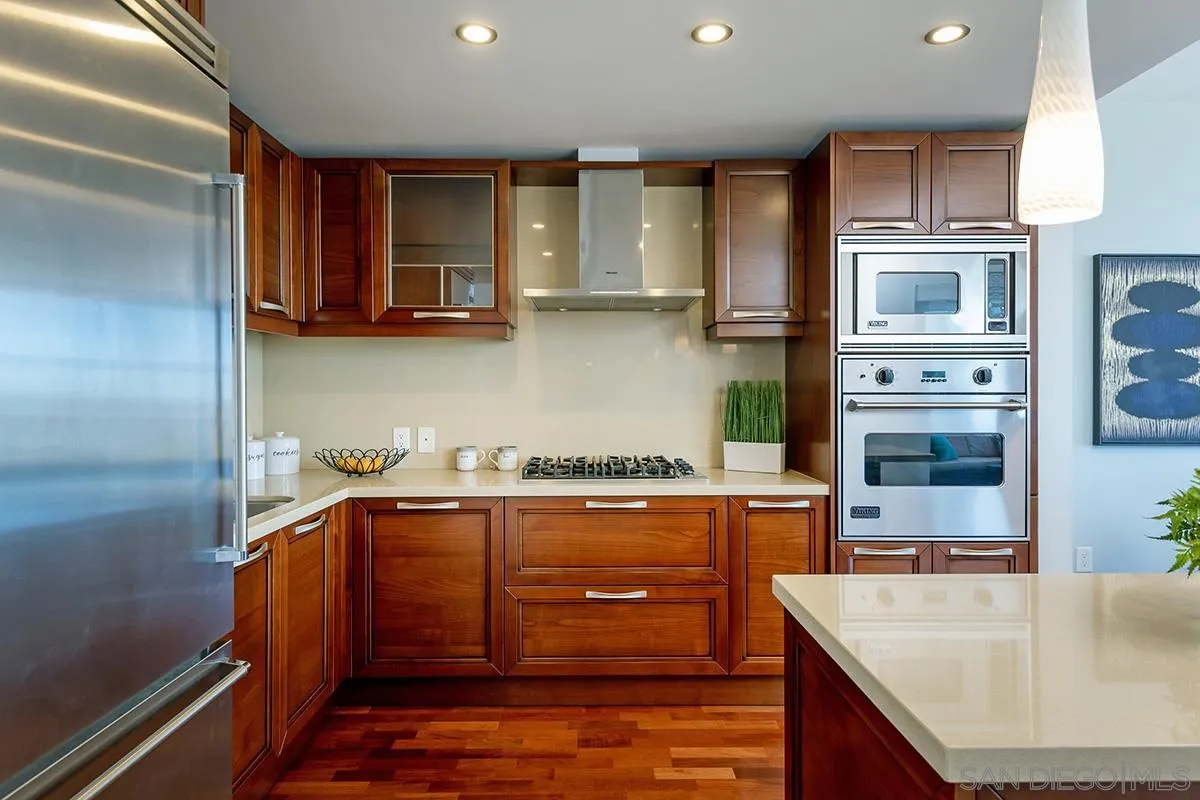 1325 Pacific Highway, Unit 2705 San Diego, CA 92101 - Photo 19 of 59 a kitchen with stainless steel appliances granite countertop a sink and a stove