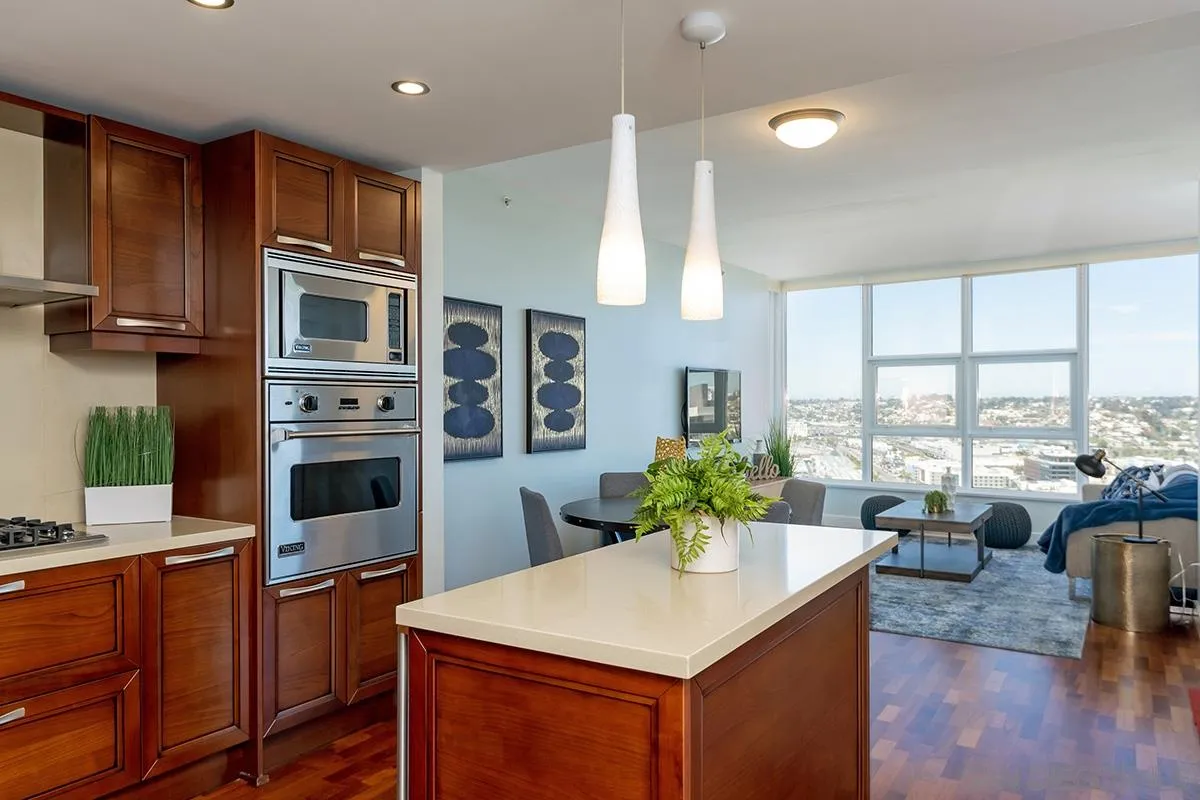 1325 Pacific Highway, Unit 2705 San Diego, CA 92101 - Photo 20 of 59 a kitchen with stainless steel appliances a stove a sink a microwave a refrigerator and cabinets