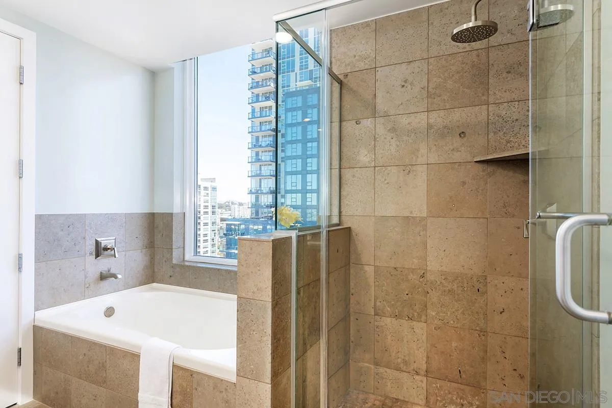 1325 Pacific Highway, Unit 2705 San Diego, CA 92101 - Photo 33 of 59 a bathroom with a tub and a shower