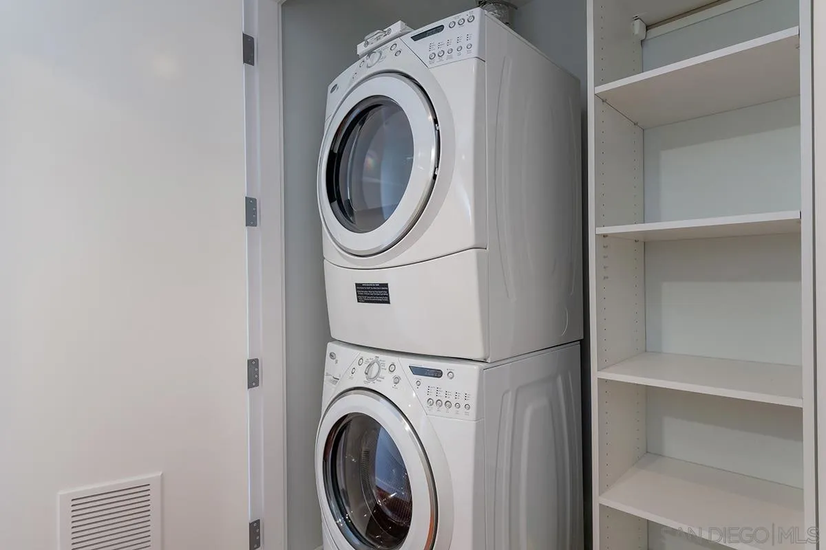 1325 Pacific Highway, Unit 2705 San Diego, CA 92101 - Photo 36 of 59 a view of a hallway with washer and dryer