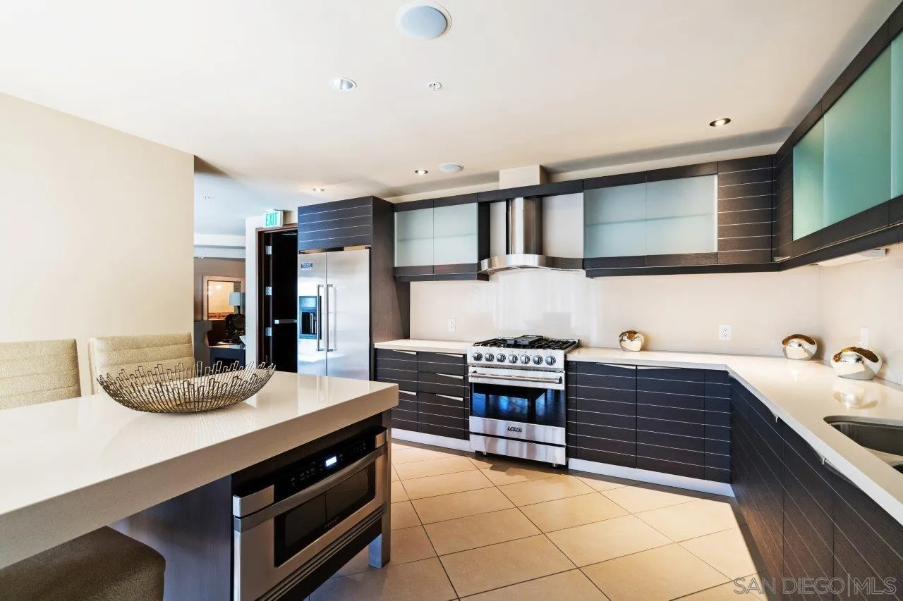 1325 Pacific Highway, Unit 2705 San Diego, CA 92101 - Photo 53 of 59 a kitchen with stainless steel appliances granite countertop a sink stove and cabinets